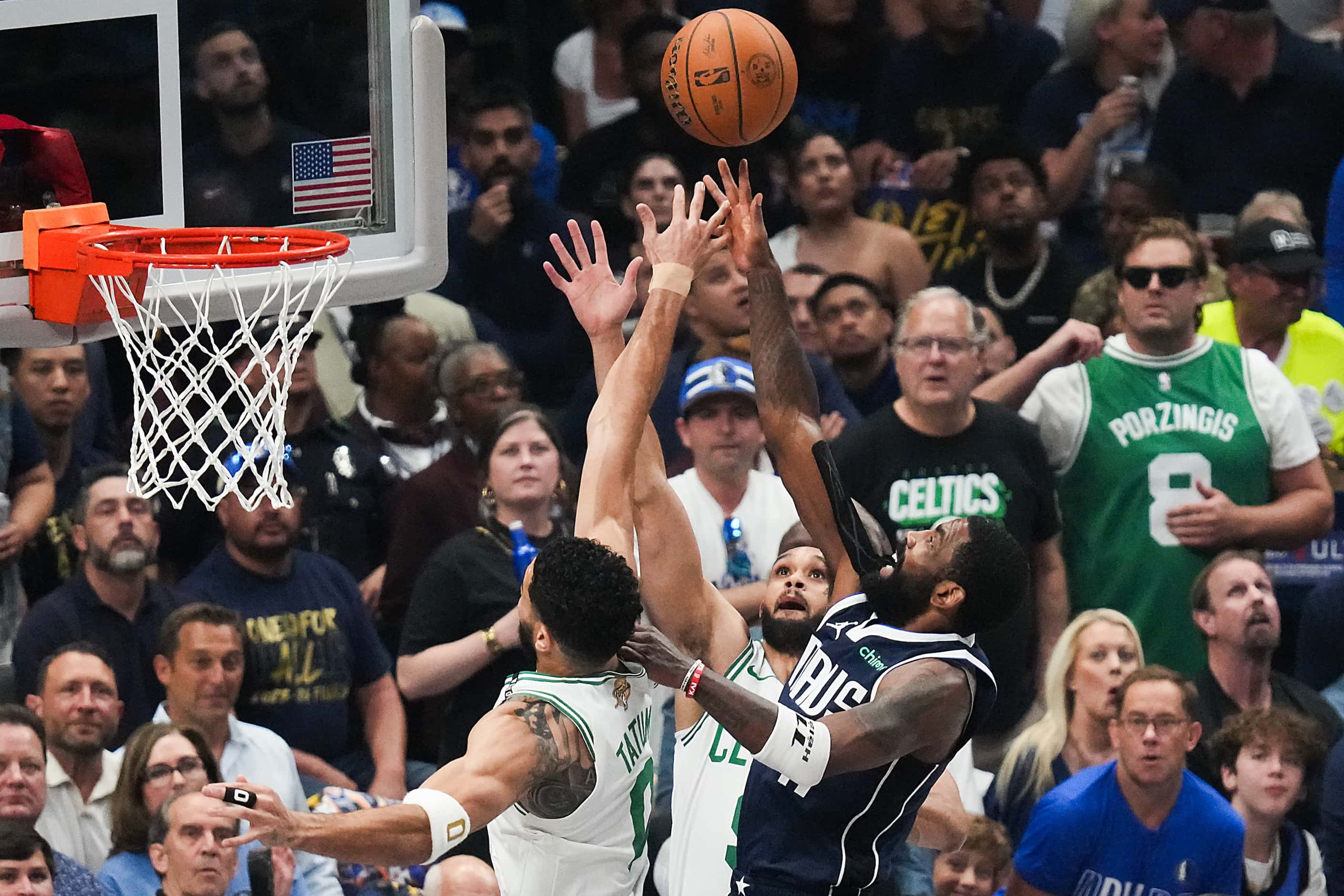 Dallas Mavericks guard Kyrie Irving (11) scores past Boston Celtics forward Jayson Tatum (0)...