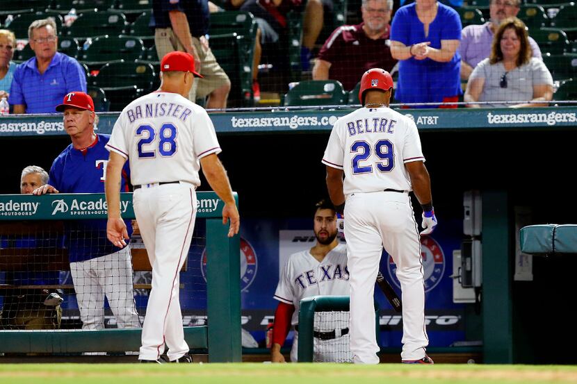 Texas Rangers third baseman Adrian Beltre (29) and manager Jeff Banister walk to the...
