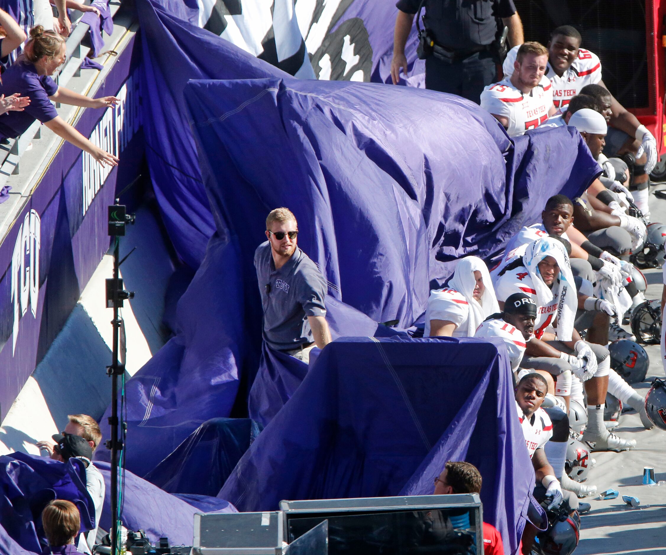 A large TCU flag comes out of the stands and accidentally drapes over the Red Raiders bench...