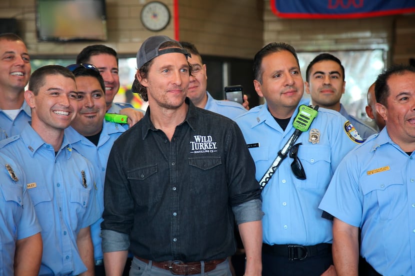 This Oct. 28, 2018 photo shows actor Matthew McConaughey posing with first responders in...