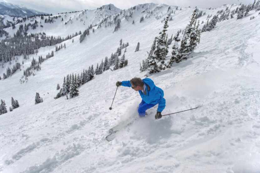 A skier heads down Campbell Basin at Crystal Mountain, Wash., in late March. The resort has...