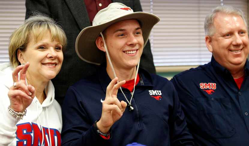 
SMU signee Joshua Williams poses with his parents, Susan and David Williams, after signing...