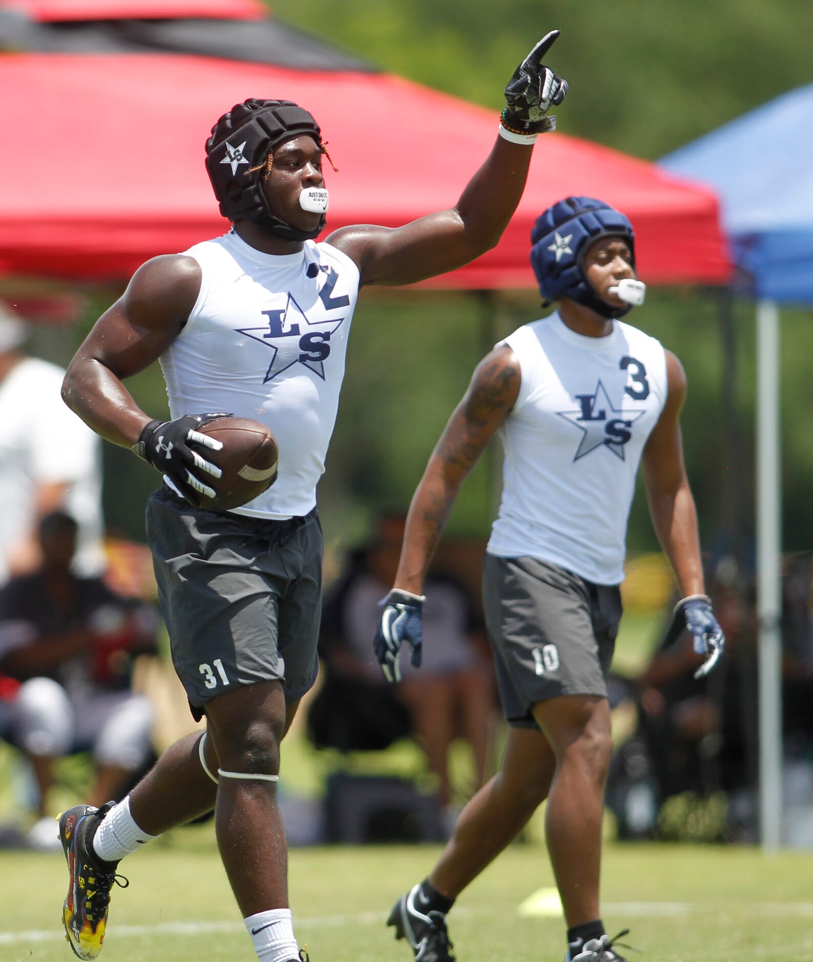 Frisco Lone Star receiver Ashton Jeanty (2) gestures long distance to quarterback Garrett...