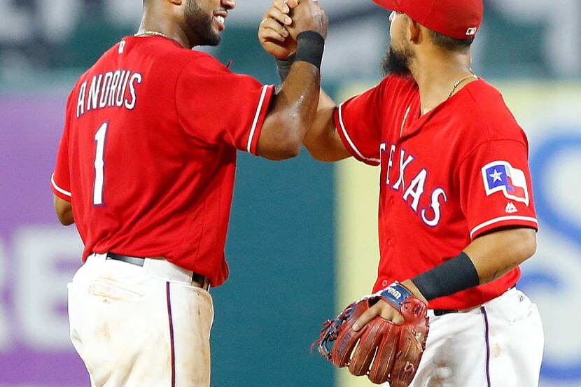 Texas Rangers shortstop Elvis Andrus (1) and second baseman Rougned Odor (12) congratulate...