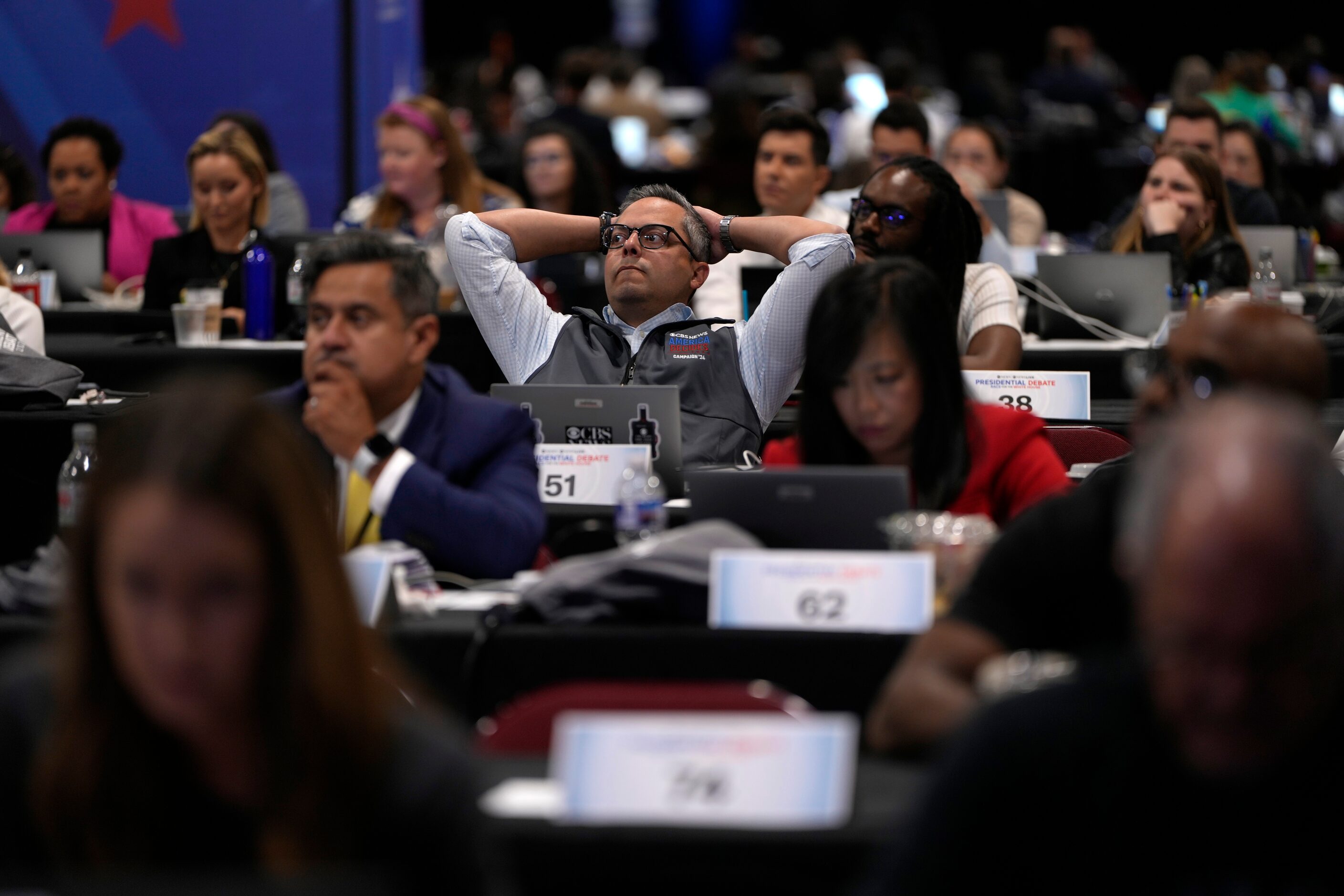 Members of the press appear in the spin room during a presidential debate between Republican...