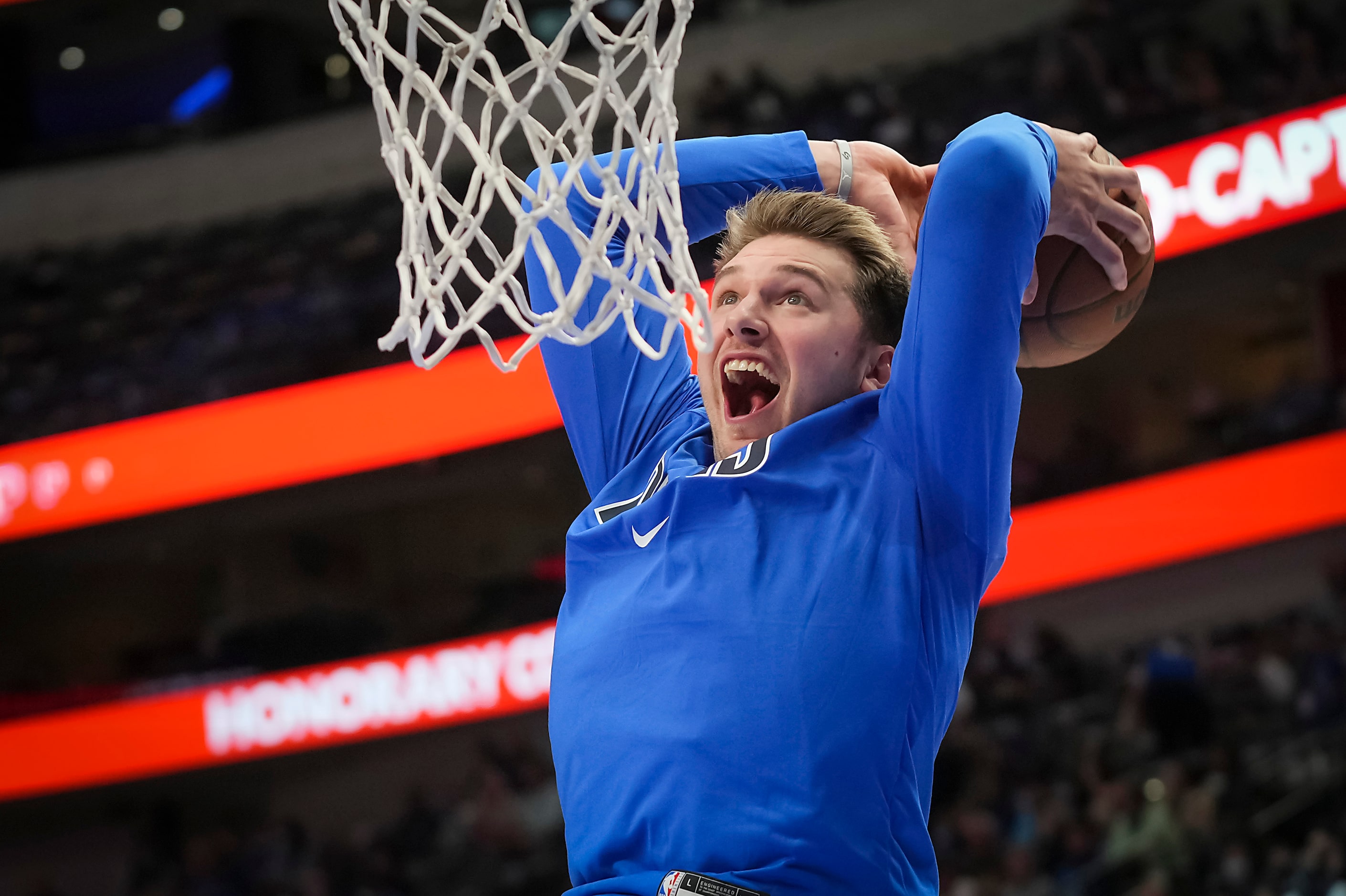 Dallas Mavericks guard Luka Doncic dunks the ball during warm up before an NBA basketball...