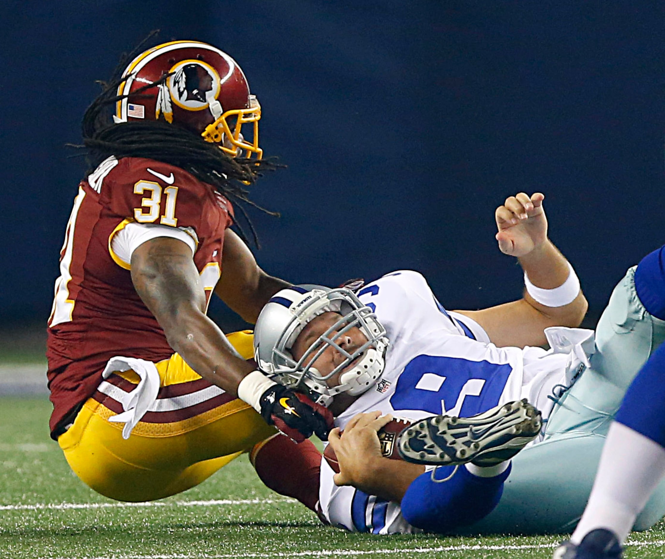 Dallas Cowboys quarterback Tony Romo (9) is sacked by Washington Redskins strong safety...