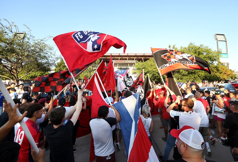 Fans join a parade as the gates to open for an FC Dallas game at Toyota Stadium in Frisco,...