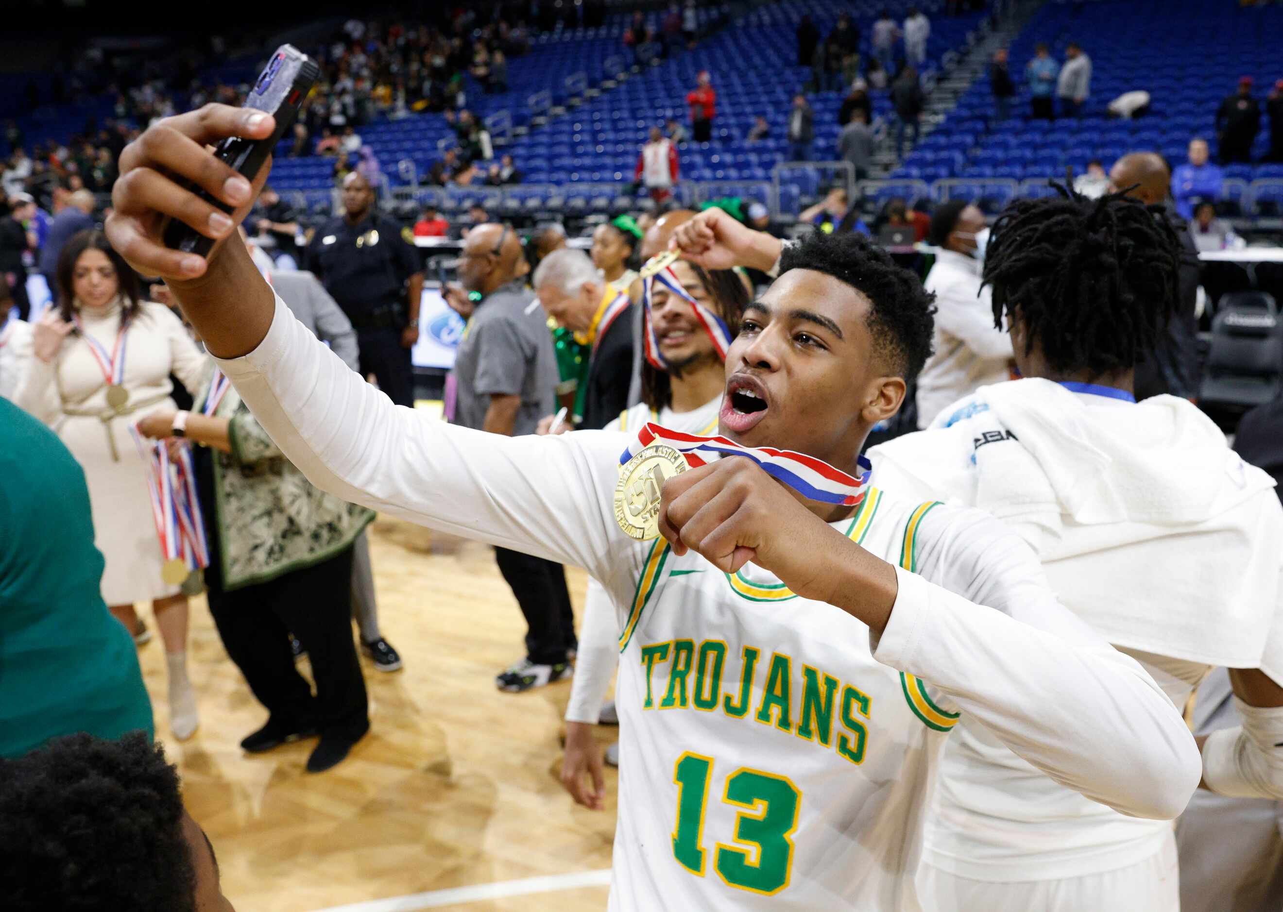 Madison forward Rodney Geter (13) takes a selfie with his state championship medal after...