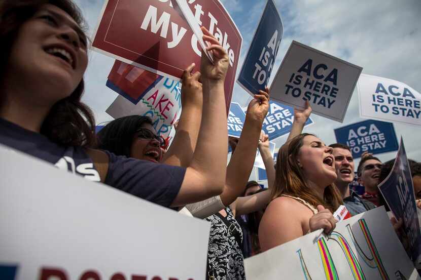 
Demonstrators react after the ruling in King v. Burwell, a challenge to the Affordable Care...