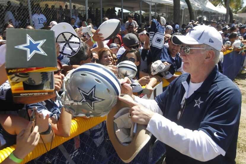 Dallas Cowboys owner Jerry Jones signs autographs for a crowd estimated to be over 9,000...