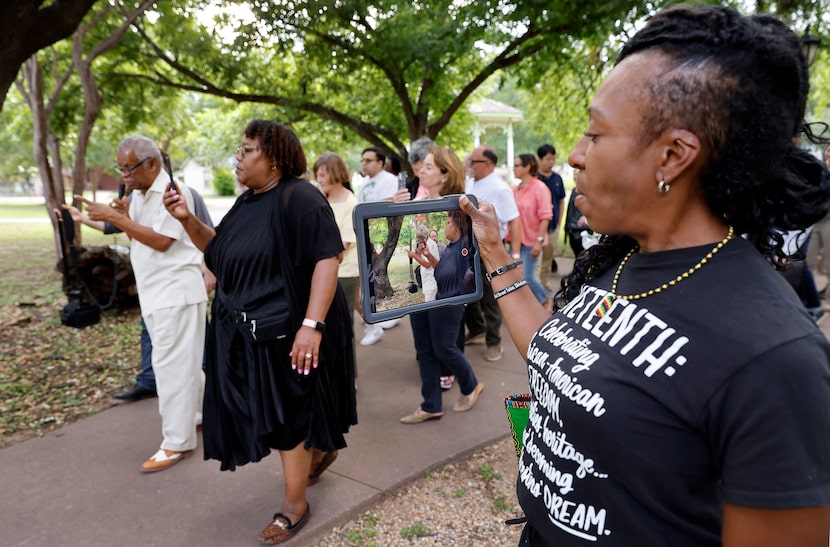 Kristy Finley (right) records historian Donald Payton who leads a walking tour of Old City...