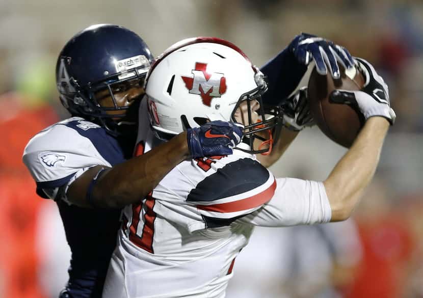 Flower Mound Marcus' Alex Albright (20) catches a pass for a touchdown in front of Allen's...