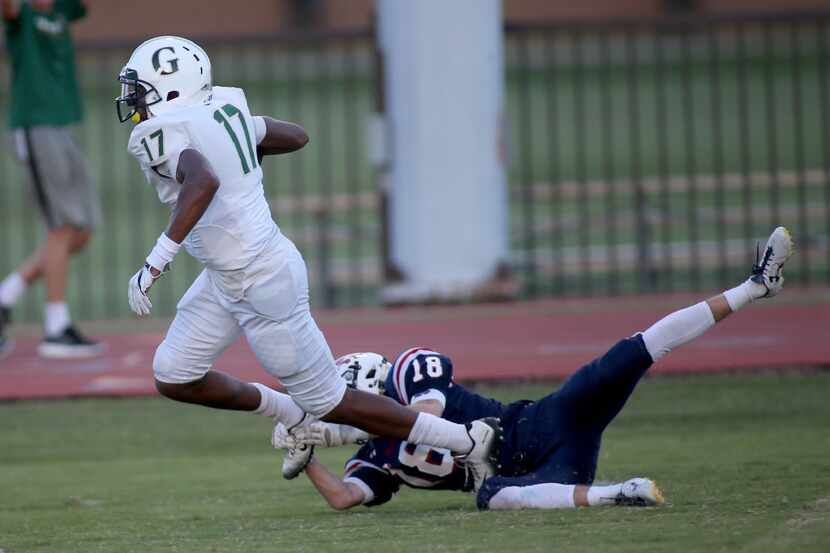 Fort Worth Country Day's Turner Symonds, 18, misses a shoestring tackle of Greenhill...