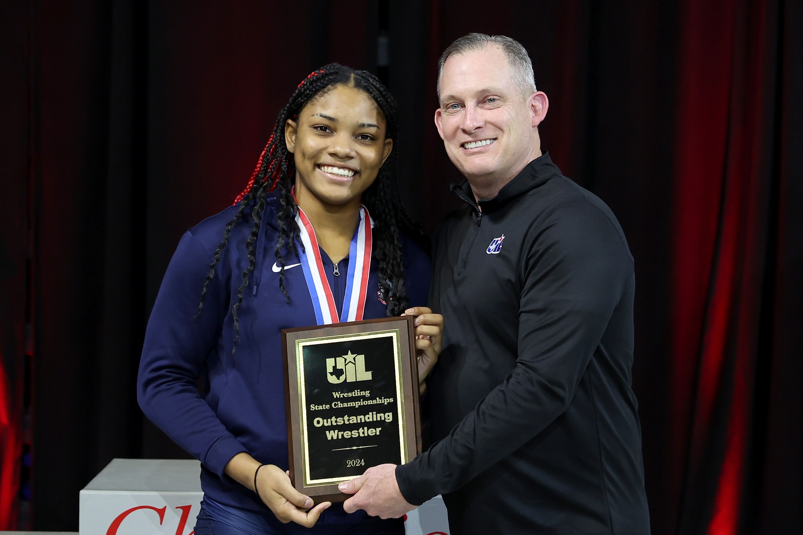 Jasmine Robinson of Allen is awarded the Outstanding Wrestler Award in the 6A girls division...