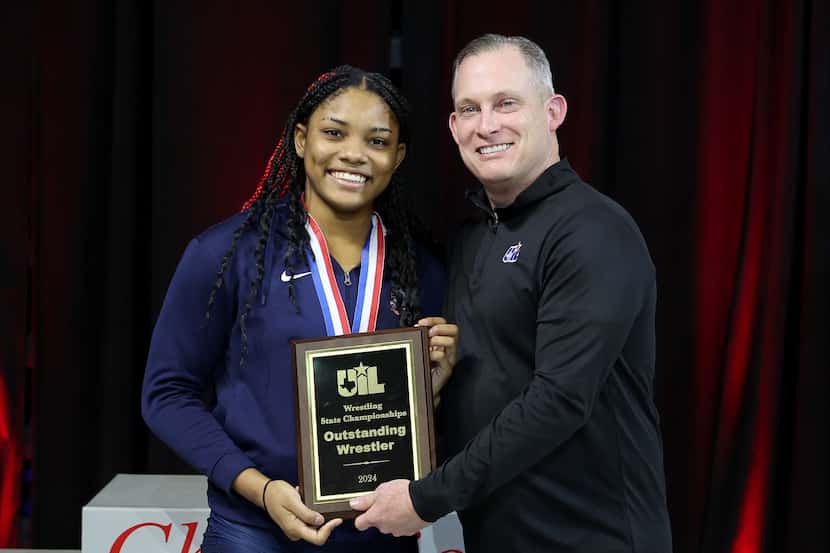 Jasmine Robinson of Allen is awarded the Outstanding Wrestler Award in the 6A girls division...