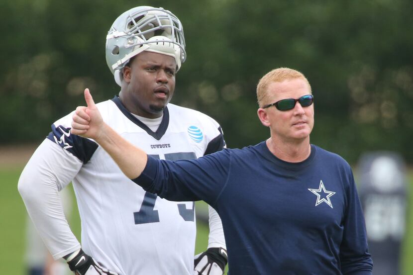 Jason Garrett and offensive tackle Cameron Fleming (75) are pictured at minicamp in Frisco...