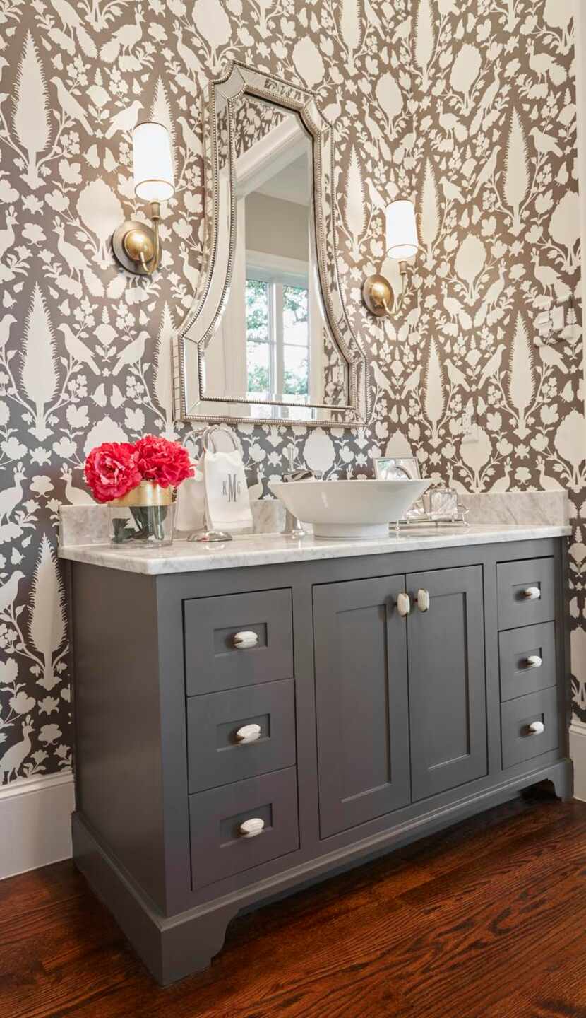 A bold wallcovering from Schumacher creates instant interest and drama in a guest bathroom....