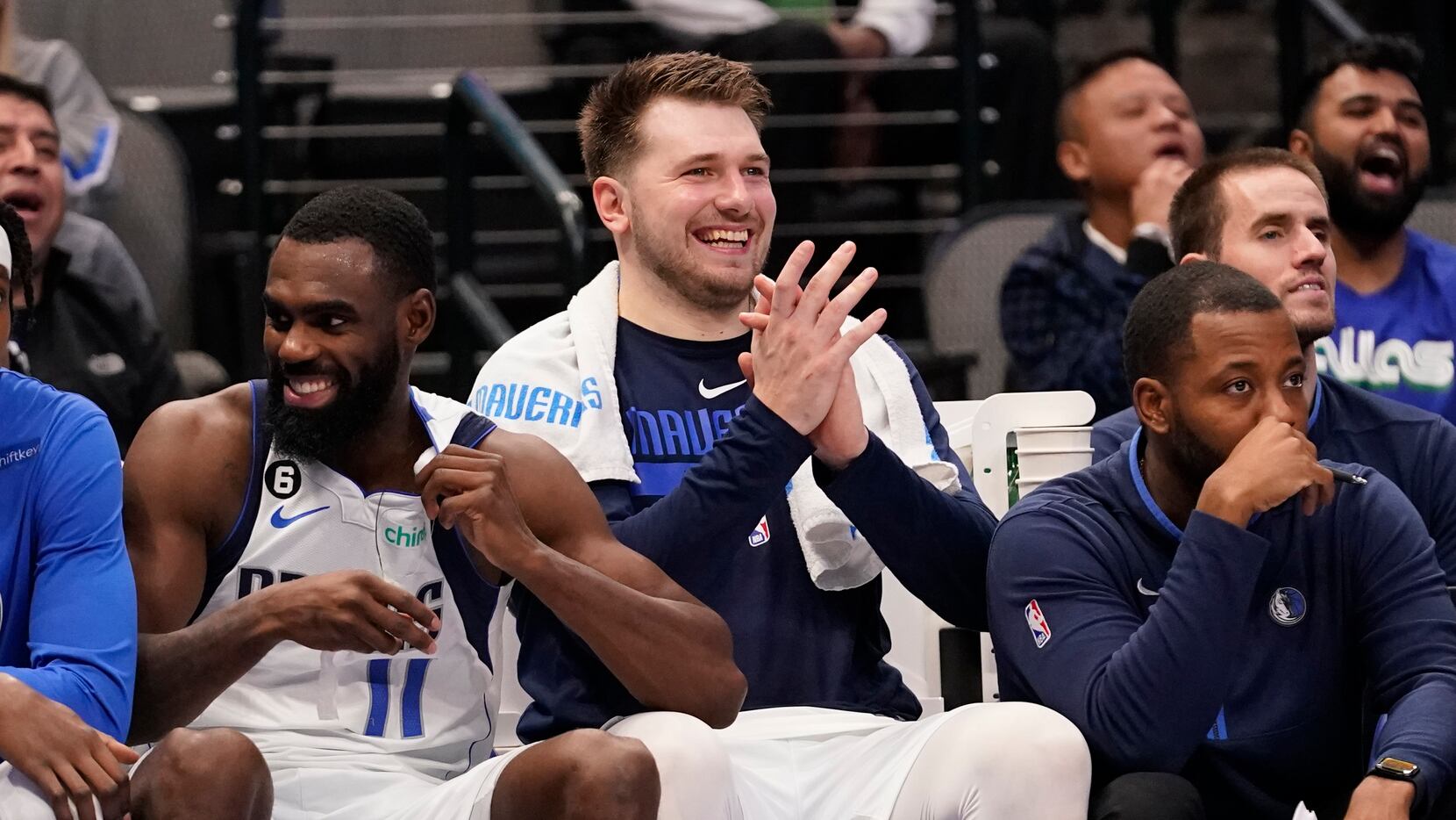 Dallas Mavericks guard Luka Doncic, center, watches from the bench with teammate forward Tim...