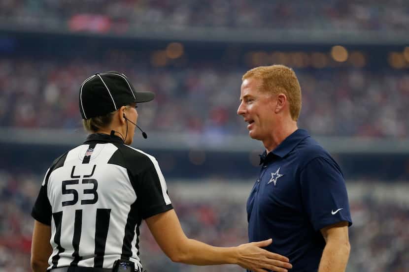 Line Judge Sara Thomas listens to Dallas Cowboys head coach Jason Garrett during the first...