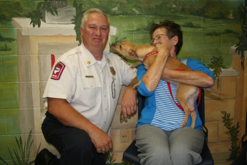 Lily gets feisty with Lancaster Fire Chief Thomas Griffith and volunteer Rusty Lemley.
