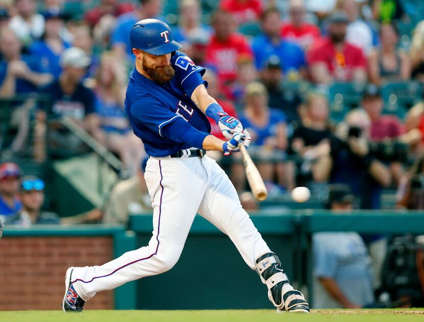 With bases loaded in the third inning, Texas Rangers catcher Jonathan Lucroy connects on a...