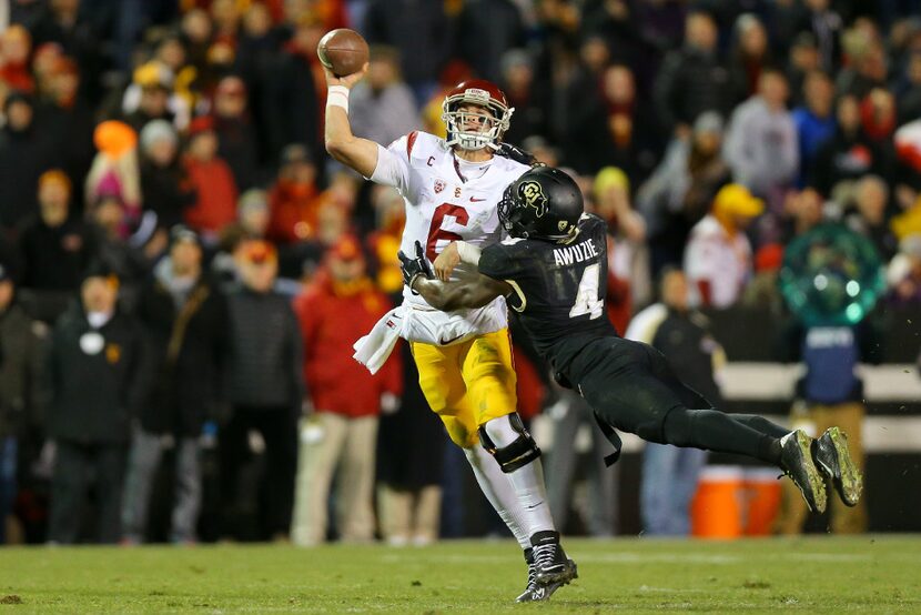 BOULDER, CO - NOVEMBER 13:  Quarterback Cody Kessler #6 of the USC Trojans is hit by...