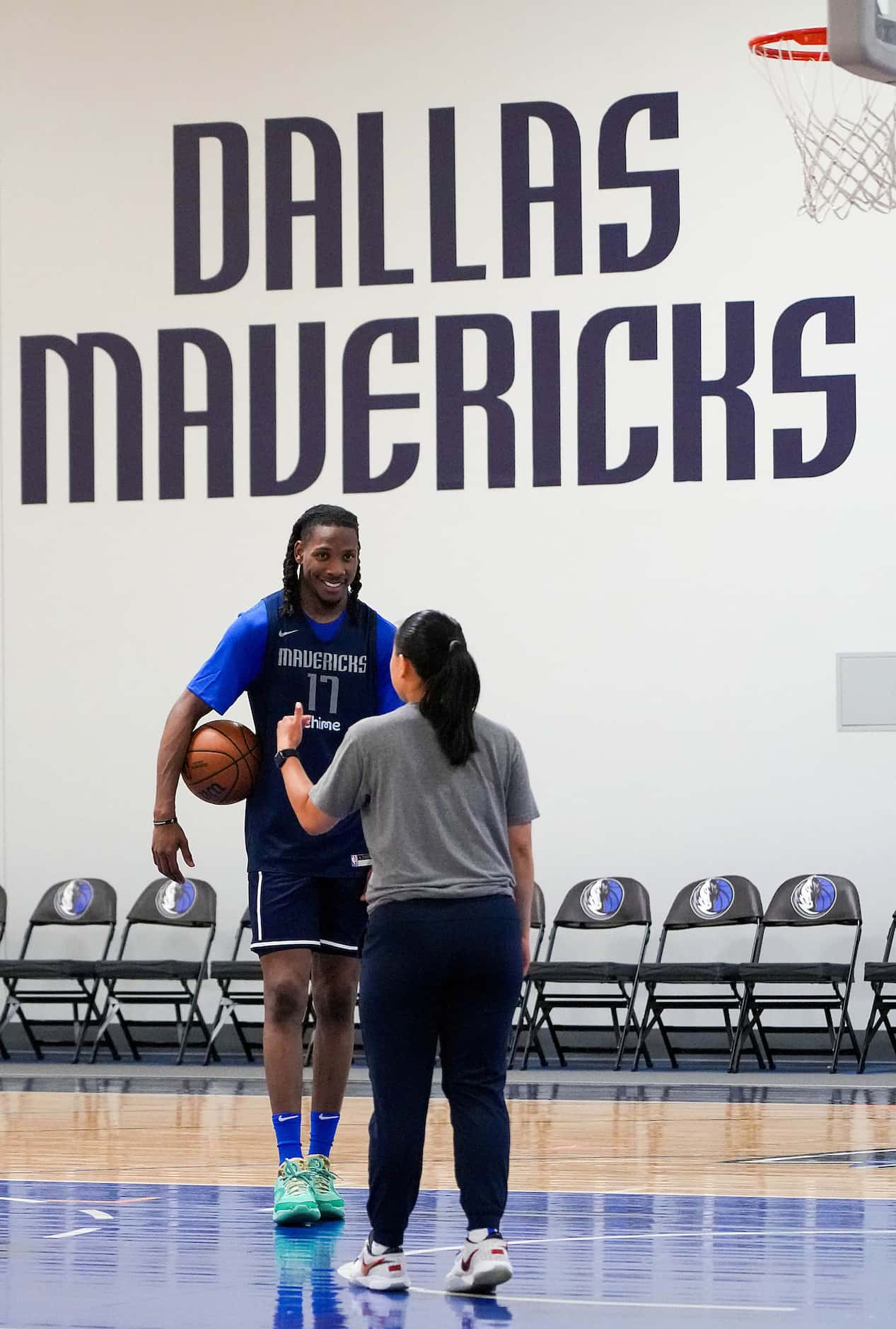 Dallas Mavericks forward Melvin Ajinca (17) talks with assistant coach Shannan Lum during a...