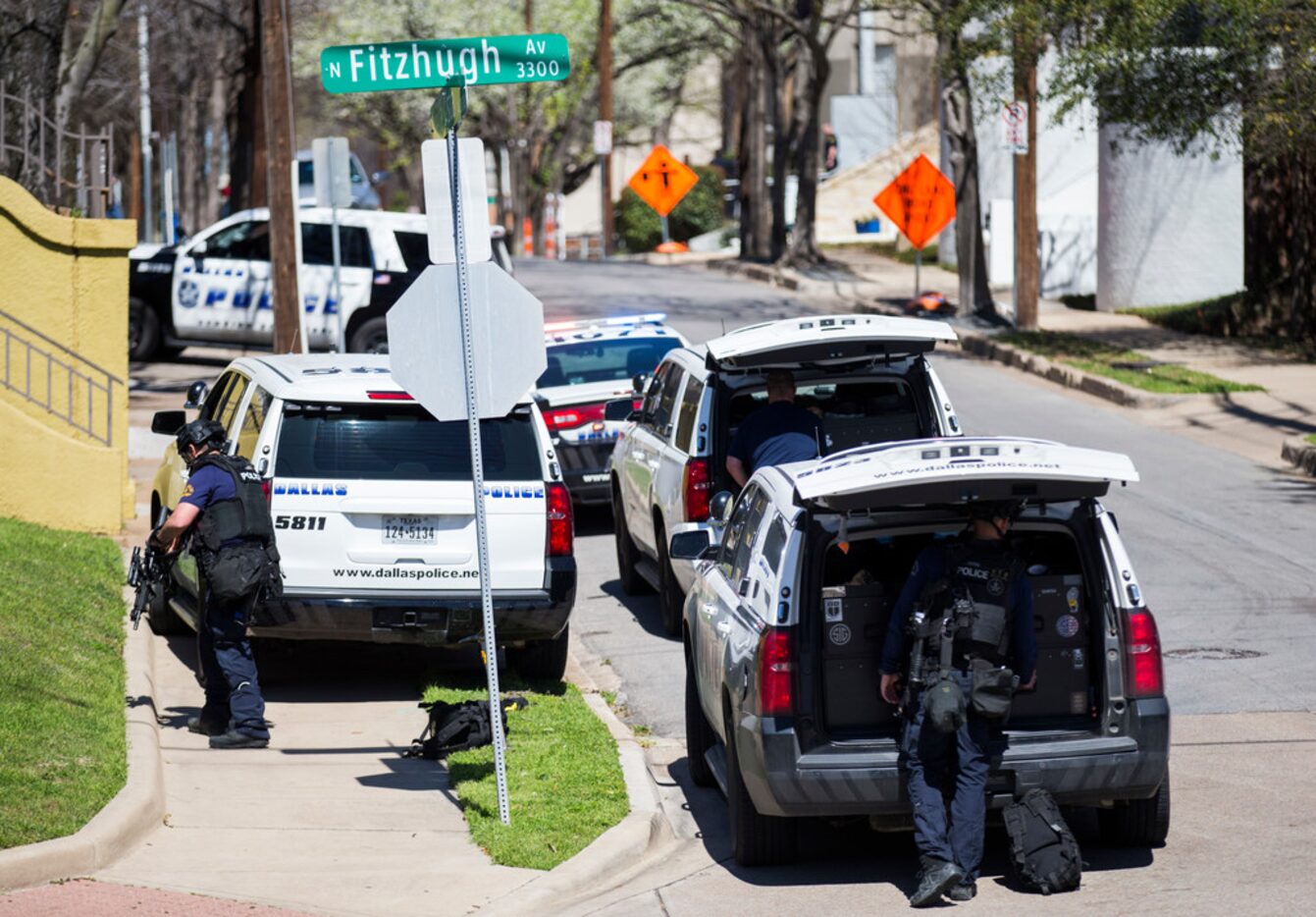 SWAT officers return to their vehicles after an incident near the corner of Fitzhugh and...