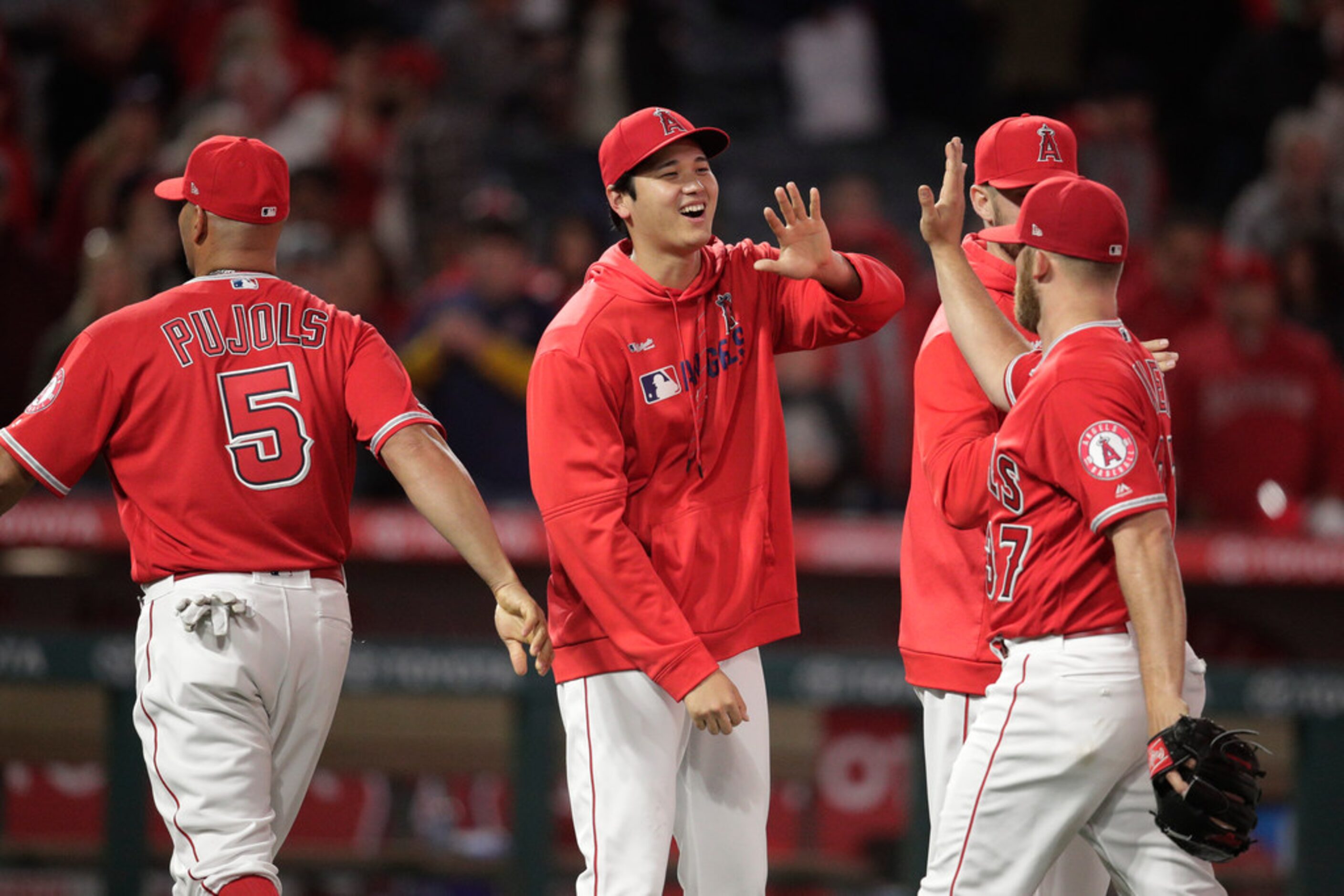 Los Angeles Angels' Shohei Ohtani, center, of Japan, celebrates the team's 3-1 over the...