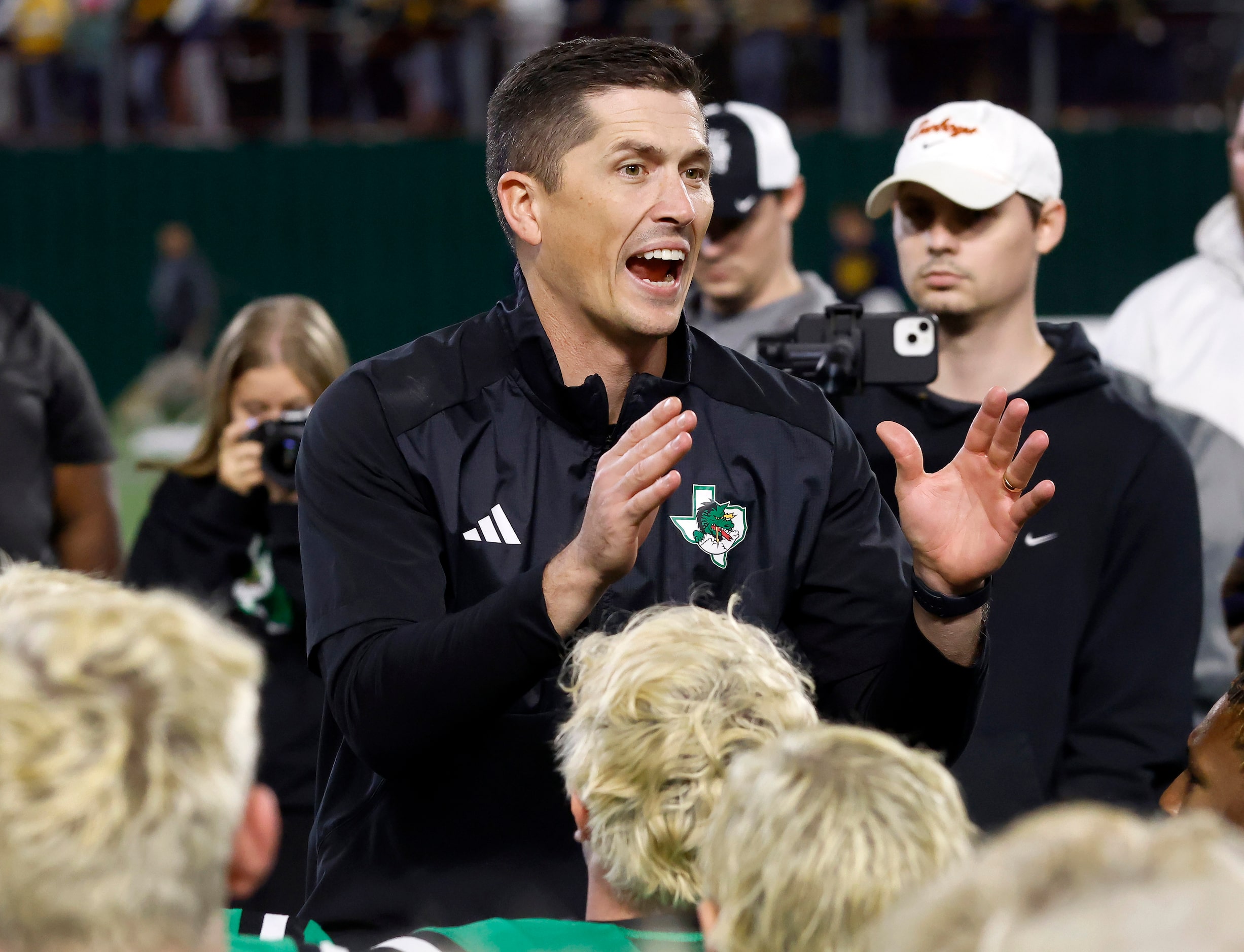 Southlake Carroll head coach Riley Dodge huddles his players for a post game huddle after...