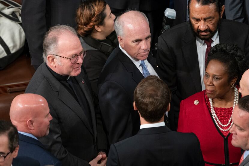 Chaplain of the House of Representatives the Rev. Patrick J. Conroy (second from left)...