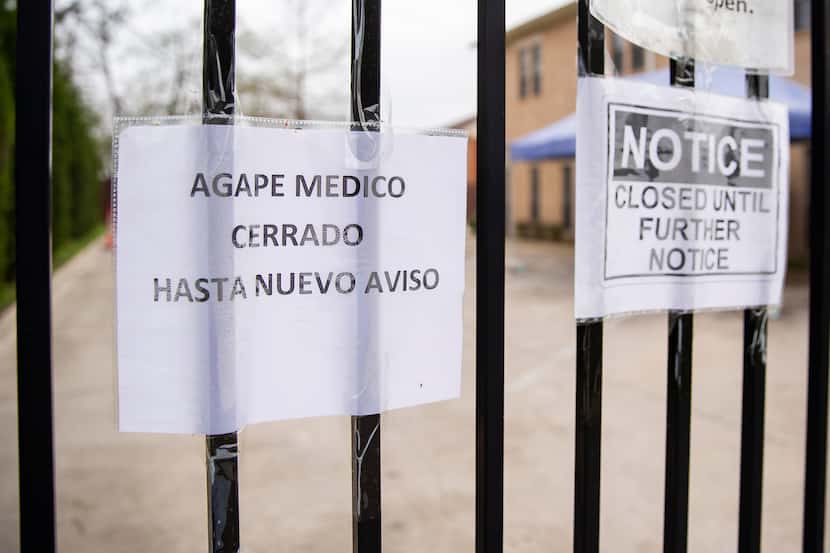 Signs in Spanish and English announce the closure of the Agape Clinic on March 16, 2020 in...