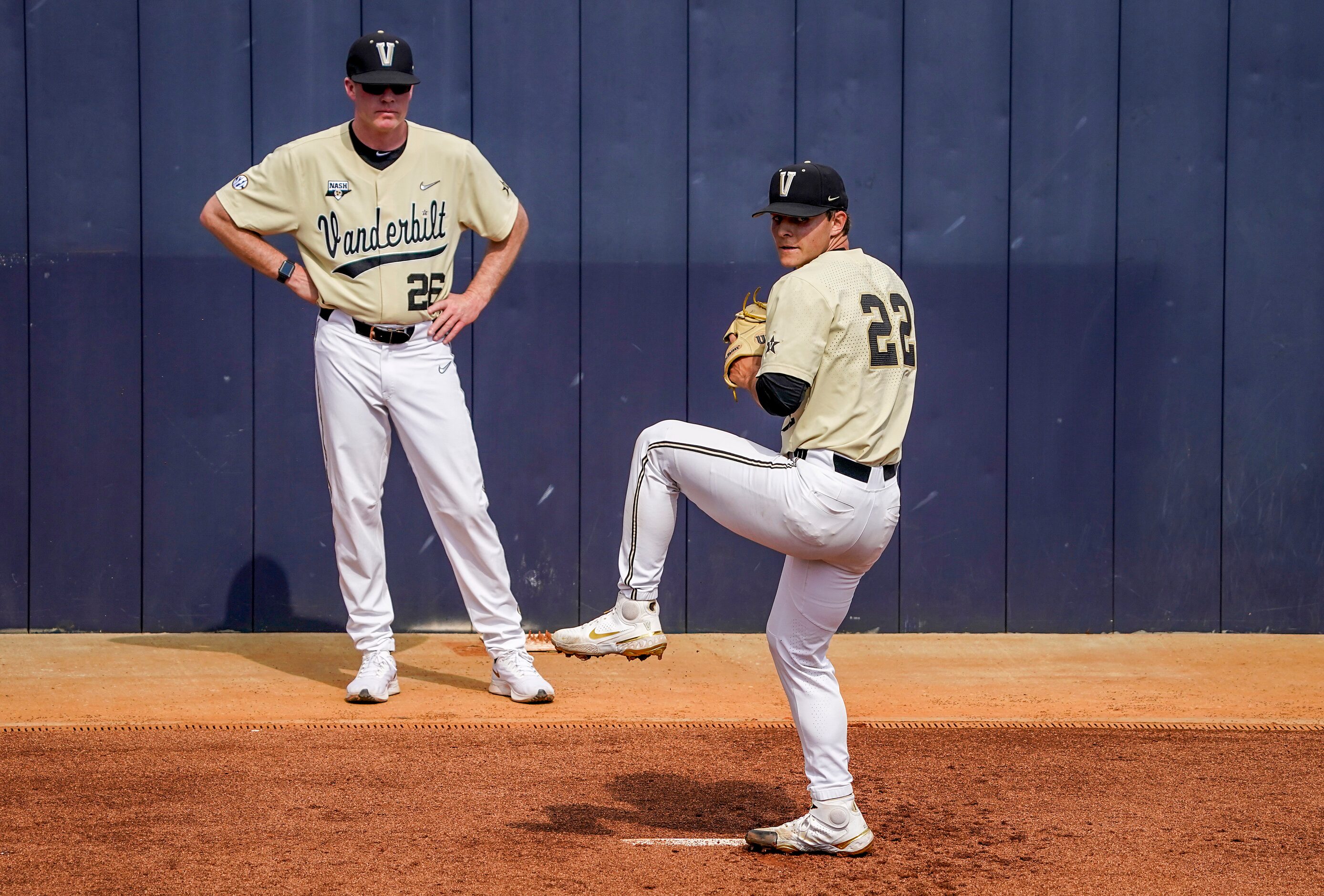 Vanderbilt pitcher Jack Leiter warms up as associate head coach Scott Brown looks on before...