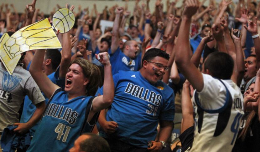 Ricky Pacheco, left, cheers as the Mavs go ahead on the scoreboard during the watch party at...