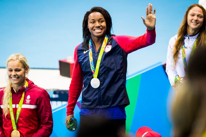 Simone Manuel of the USA waves to the crowd after receiving her silver medal for the women's...