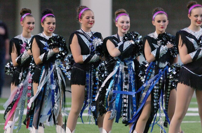 Members of the Guyer High drill team wear their homecoming mums before a game in Denton....