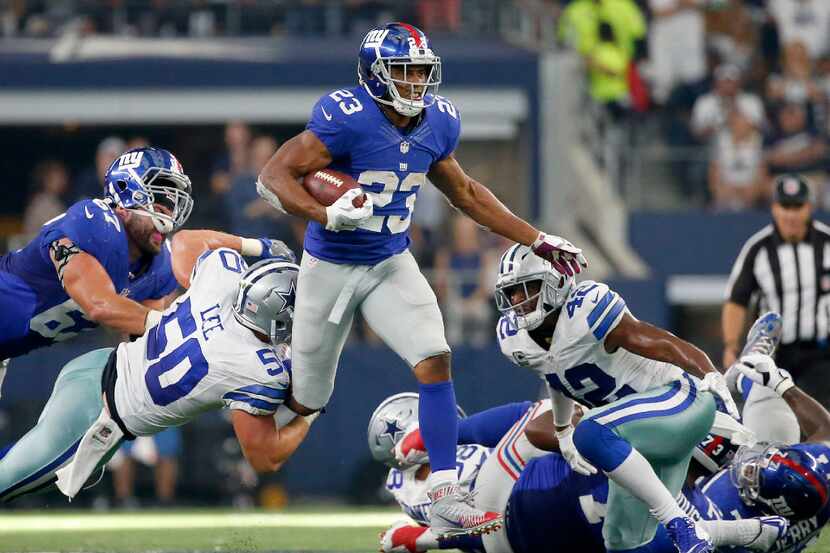 New York Giants running back Rashad Jennings (23) is tackled by Dallas Cowboys outside...