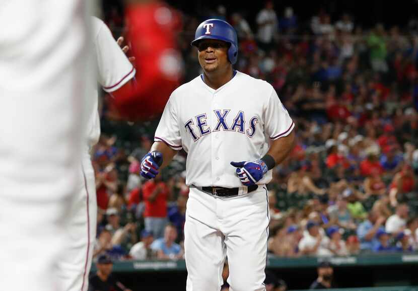 Texas Rangers' Adrian Beltre, right, is greeted by teammates following his two-run home run...