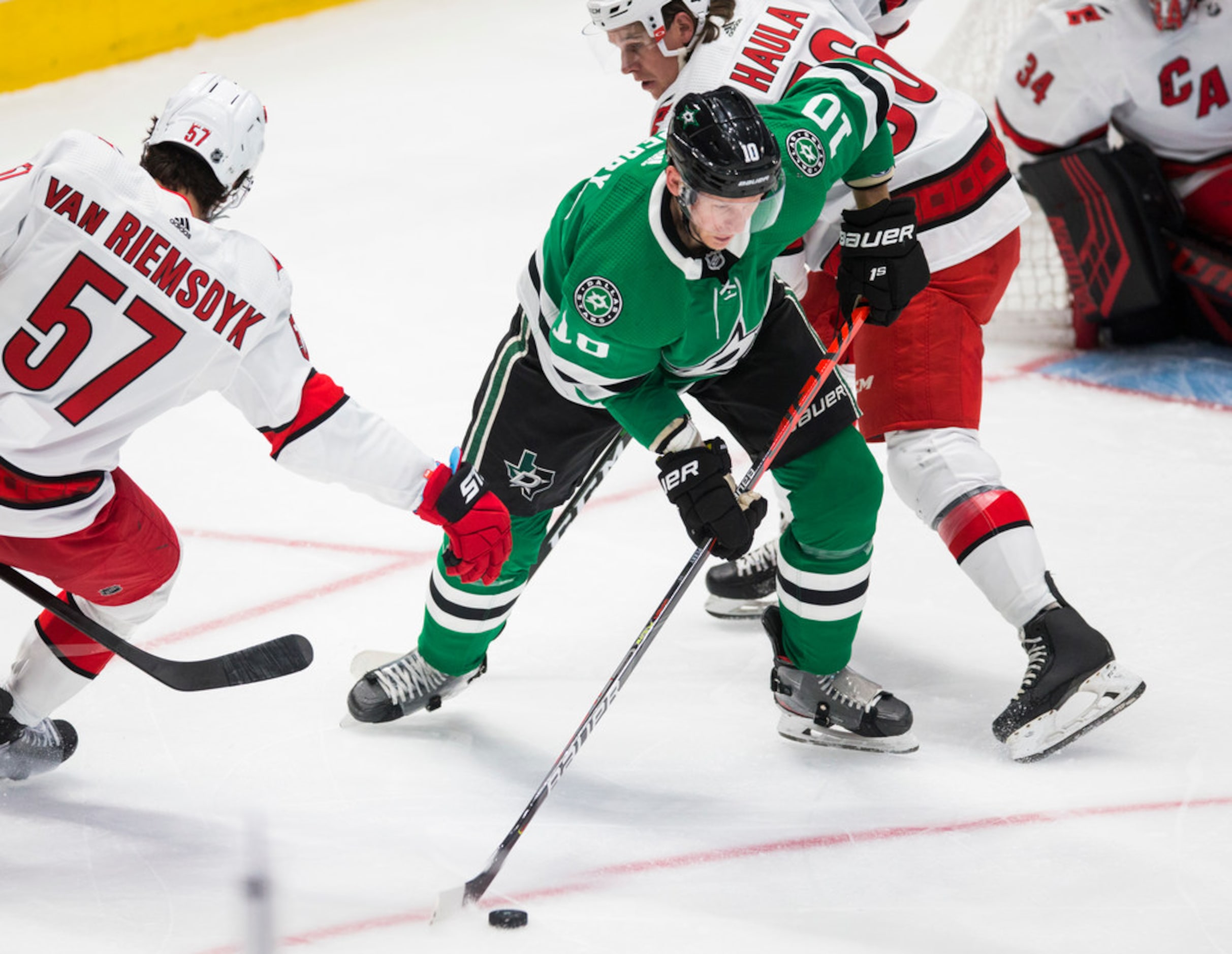 Dallas Stars right wing Corey Perry (10) takes control of the puck from Carolina Hurricanes...