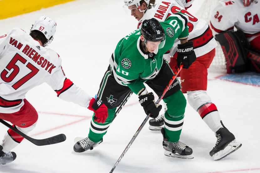 Dallas Stars right wing Corey Perry (10) takes control of the puck from Carolina Hurricanes...