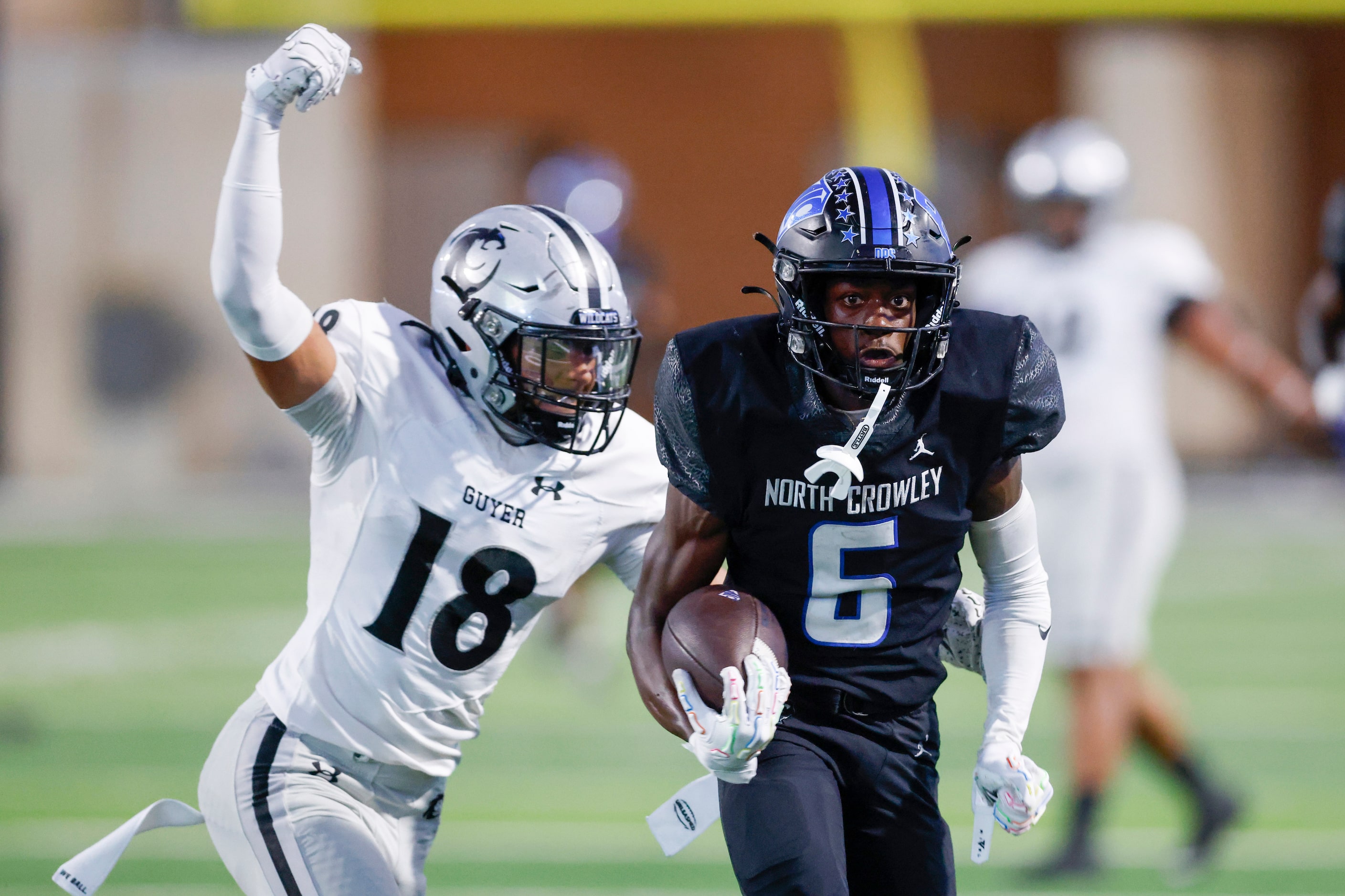 North Crowley wide receiver Quentin Gibson (6) runs for a touchdown ahead of Denton Guyer...