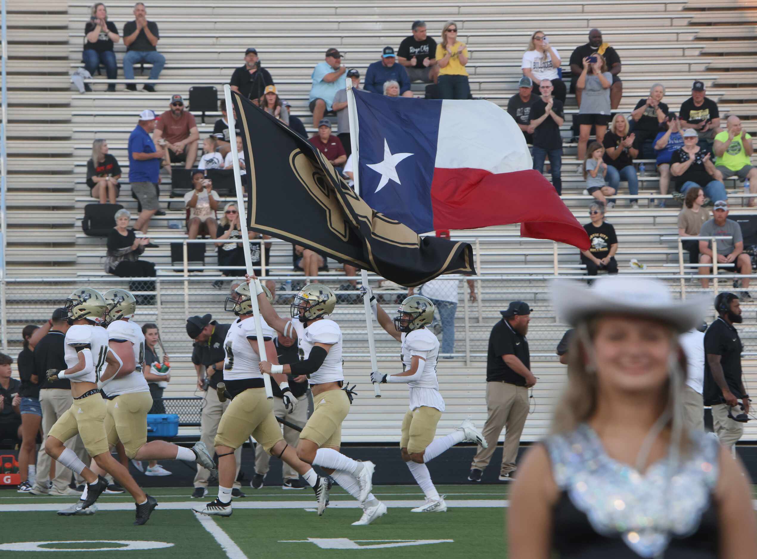 Royse City players run onto the field prior to the opening kickoff of their game against...
