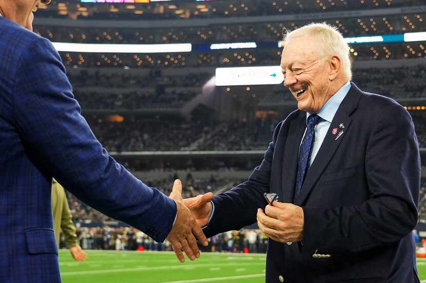 Dallas Cowboys owner and general manager Jerry Jones shakes hands on the sidelines before an...