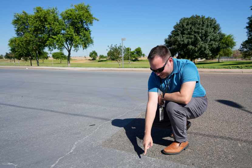 Ryan Stevens, engineering manager in street maintenance for the city of Phoenix, points out...