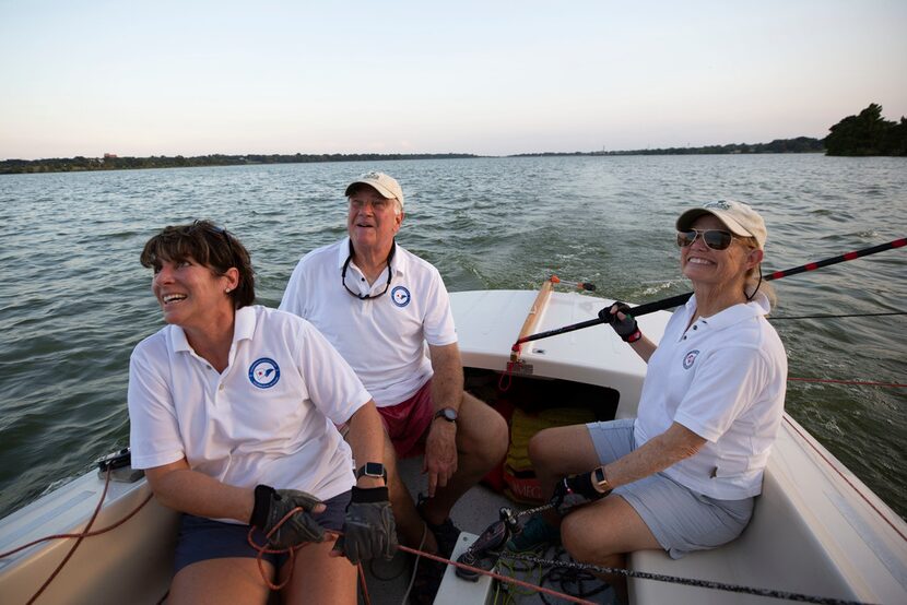 Ralph "Red Dog" Jones (center) sails White Rock Lake with Heidi Gough (CQ), left, and Bowman...