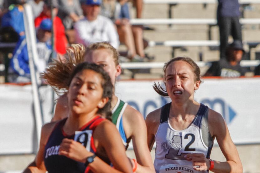 Liberty Christian's Elizabeth Reneau, right, competes in the girls 1600 meter run during the...
