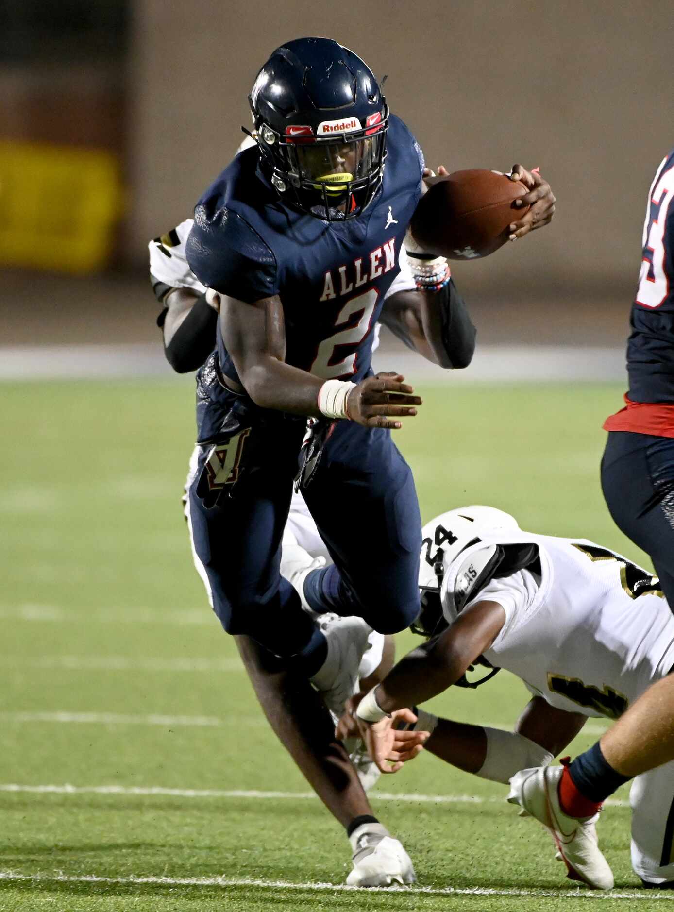 Allen’s Jaylen Jenkins (2) runs through tackle attempts by Plano East’s Daniel Oliver and...