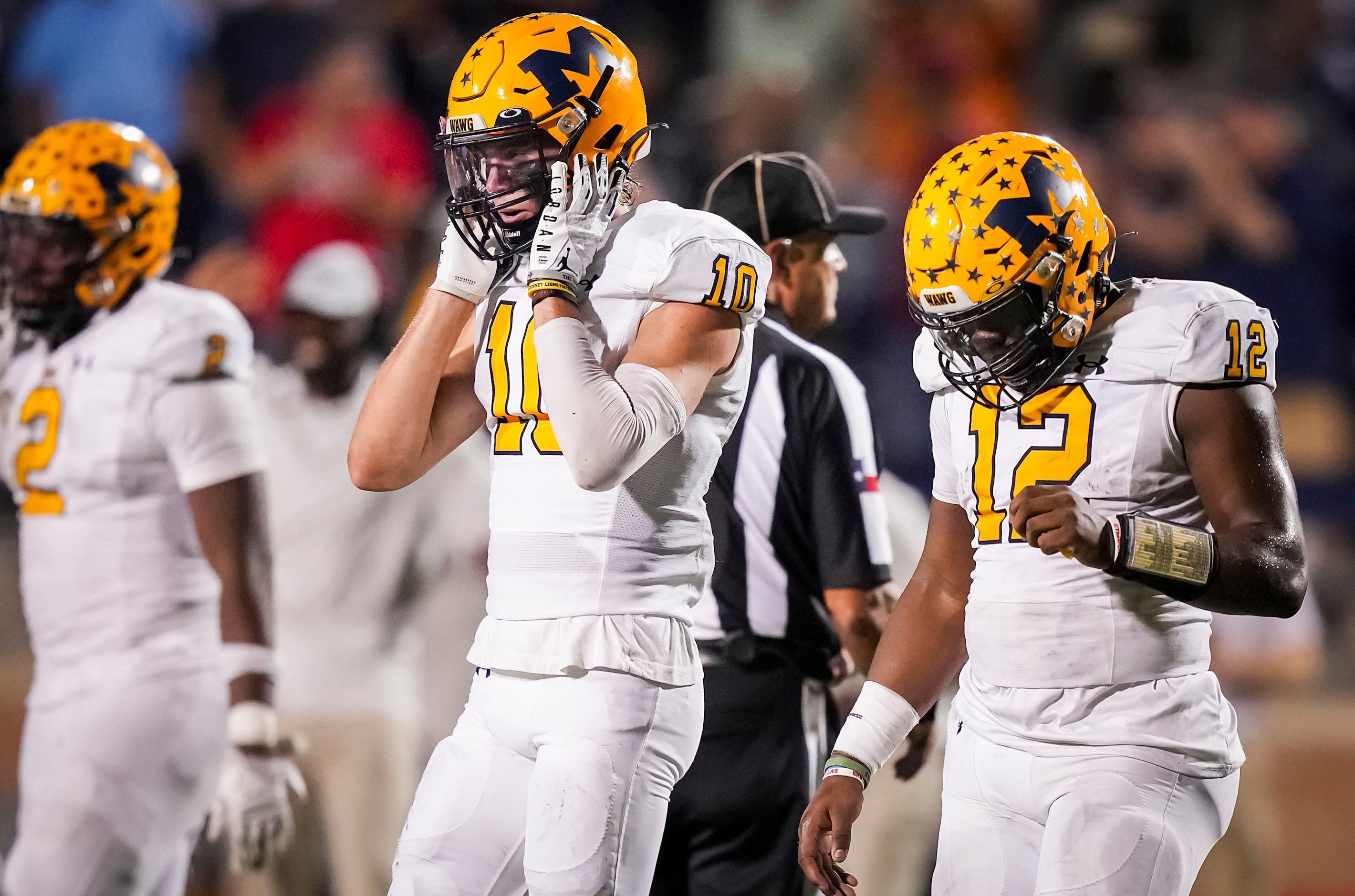 McKinney quarterback Keldric Luster (12) and wide receiver Dylan Rhodes (10) head to the...