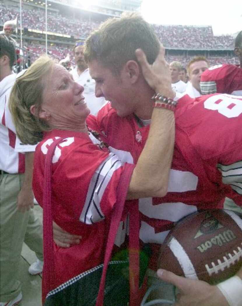 Ohio State kicker Mike Nugent is congratulated by his mother, Carolyn, after his 55-yard...